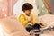 Boy with pots playing music in kids tent at home