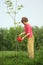Boy pours on seedling of tree