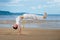 Boy practicing capoeira on the beach. Guy performs a handstand.