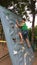 Boy practicing wall climbing in garden area