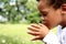 Boy praying with closed eyes stock photo