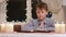 Boy praying at the table.