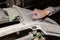 A boy prepares a car body element for painting after an accident with the help of abrasive paper in a car repair shop. Recovery