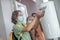 Boy in preventive mask getting some sanitizer into his hand
