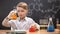 Boy in protective glasses mixing chemical liquids in flasks, curious genius