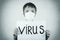 Boy in protective mask holds inscription virus. Special effect. Healthcare and medical concept