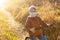 A boy in a protective mask rides a balance bike