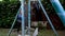 A boy punches a punching bag in blue gloves in the yard