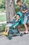 Boy pushes stroller with sitting younger brother in park