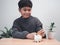 A boy putting coins into piggy bank. Learning financial responsibility and projecting savings. savings concept. investment concept