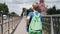 The boy quickly runs across the bridge over the river. Cool dynamic shots. Sports lifestyle.