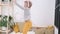 Boy in rabbit bunny ears on head jumping on white bed. Excited caucasian child in yellow pants having fun at home enjoy