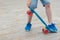 Boy raises sport board with his feet, on stone paving, close-up