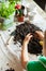 Boy with rake playing with soil on table