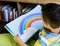 Boy Reading Children Story Book in Library