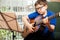 Boy reading a guitar sheet music