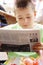 Boy reading newspaper