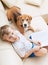 Boy reading tales for his dog at home