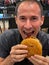 Boy ready to enjoy a delicious hamburger.