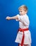 Boy with red belt beats blow arm