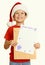 Boy in red hat with letter to santa - winter holiday christmas concept, yellow toned