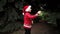 boy in a red knitted Christmas sweater with a Christmas reindeer and Santa hat