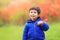 Boy with a red maple leaf attached in the heart region with great pride as Canadian citizen. Portrait of little white Caucasian b