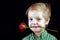 Boy with a red rose. Boy holds a rose in his teeth. Mother`s Day Concept, Valentine`s Day