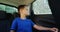 Boy relaxing in the back seat of car