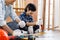 Boy remove nail from timber using hammer.