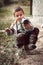 Boy remove sand from his shoe. Young boy trying to remove sand from his shoe