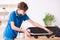 Boy reparing skateboard at home