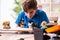 Boy reparing skateboard at home