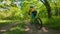 A boy rides a bicycle on a path in the forest. The road in the spring park.