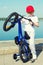 Boy rides a bicycle on the waterfront.