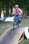 Boy rides his bike over a ramp during skill training