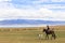 Boy rides horse at Song Kul Lake in Kyrgyzstan