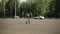 The boy rides on roller skates on a large asphalt platform