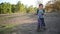 The boy rides on a runbike in the park in summer sunny weather having a good mood