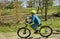 Boy riding bike near the forest. Travelling background. Summer outdoor activity. Healthy lifestyle.