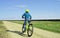 Boy riding the bike. Summer outdoor activity. On sport. Travelling background.