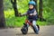 A boy riding runbike in a park