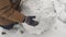 Boy rolls a big ball of snow for a snowman