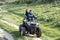 The boy rolls his girlfriend on the ATV