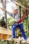 Boy on the rope track in safe equipment