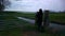 Boy in rubber boots walking alone through a pedestrian gate dutch countryside