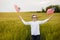 Boy runing with the american flag on the green wheat field celebrating national independence day. 4th of July concept