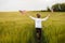 Boy runing with the american flag on the green wheat field celebrating national independence day. 4th of July concept