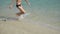 Boy running along the coastline