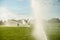 Boy running around the golf courses, which are watered with fountains